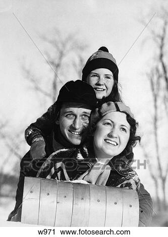 1930S Mother Father Child Lying On Tobaggan Facing Camera Smiling Hat Scarf Hood View Large Photo Image Stock Image - 1930S Mother Father Child Lying On Tobaggan Facing Camera Smiling Hat Scarf Hood . Fotosearch