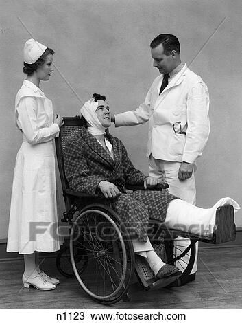 1930S Nurse Doctor And Man In Wheelchair With Bandaged Head And Foot View Large Photo Image Stock Image - 1930S Nurse Doctor And Man In Wheelchair With Bandaged Head And Foot . Fotosearch