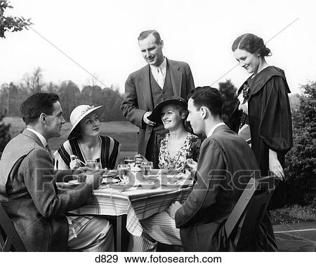 1930S Outdoor Dining Scene Two Upscale Couples Seated At Table Another Couple Standing View Large Photo Image Stock Photo - 1930S Outdoor Dining Scene Two Upscale Couples Seated At Table Another Couple Standing . Fotosearch
