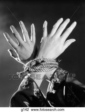 1930S Overhead Woman Hands Tied Together By Rope Flower Print Sleeves Prisoner Torture Helpless View Large Photo Image Stock Image - 1930S Overhead Woman Hands Tied Together By Rope Flower Print Sleeves Prisoner Torture Helpless . Fotosearch