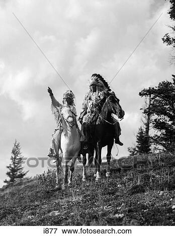 1930S Pair Of Sioux Indians In Headdresses On Horseback Pointing Out Trail View Large Photo Image Stock Photo - 1930S Pair Of Sioux Indians In Headdresses On Horseback Pointing Out Trail . Fotosearch