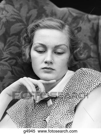 1930S Portrait Of Woman Looking Down With Sad Expression And Her Chin Resting On Index Finger View Large Photo Image Stock Photography - 1930S Portrait Of Woman Looking Down With Sad Expression And Her Chin Resting On Index Finger . Fotosearch