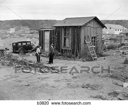 1930S Poverty Scene With 2 Boys Playing In Front Of Shack During The Depression View Large Photo Image Stock Image - 1930S Poverty Scene With 2 Boys Playing In Front Of Shack During The Depression . Fotosearch