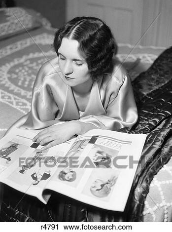 1930S Reclining Marcel Waved Woman Wearing A Light Colored Silk Satin Robe Reading A Fashion Magazine Romantic Soft Quiet View Large Photo Image Stock Image - 1930S Reclining Marcel Waved Woman Wearing A Light Colored Silk Satin Robe Reading A Fashion Magazine Romantic Soft Quiet. Fotosearch
