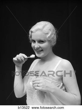 1930S Smiling Blond Woman Holding Tooth Paste And Tooth Brush Btushing Teeeth View Large Photo Image Stock Image - 1930S Smiling Blond Woman Holding Tooth Paste And Tooth Brush Btushing Teeeth . Fotosearch