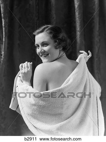 Stock Image - 1930S Smiling Brunette Woman Drying Back With Towel Looking Over Shoulder. Fotosearch
