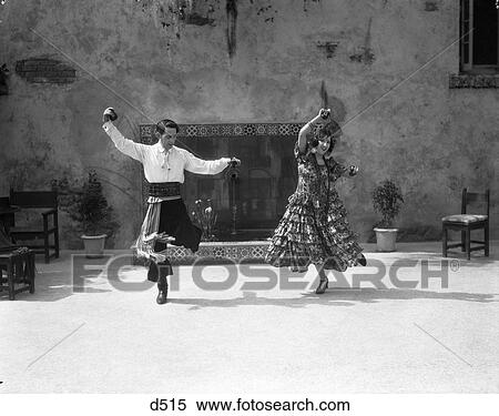 1930S Smiling Couple Dressed In Spanish Folklore Costumes Playing Castanets Dancing The Flamenco View Large Photo Image Stock Photography - 1930S Smiling Couple Dressed In Spanish Folklore Costumes Playing Castanets Dancing The Flamenco . Fotosearch