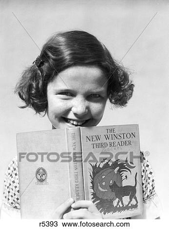 Stock Image - 1930S Smiling Girl With Bobbed Hair Holding An Open Book The New Winston Third Reader. Fotosearch