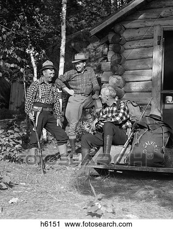 1930S Three Men Outside Hunting Lodge Cabin Plaid Shirts Fashion Rifle Camp Lake Of The Woods Ontario View Large Photo Image Stock Image - 1930S Three Men Outside Hunting Lodge Cabin Plaid Shirts Fashion Rifle Camp Lake Of The Woods Ontario . Fotosearch