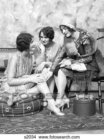 1930S Three Well Dressed Women One Wearing A Cloche & Fox Fur Collar In Conversation Seated Oriental Rug Moroccan Hassock Hatbox View Large Photo Image Picture - 1930S Three Well Dressed Women One Wearing A Cloche & Fox Fur Collar In Conversation Seated Oriental Rug Moroccan Hassock Hatbox. Fotosearch