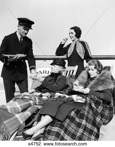 1930S Three Women Being Served Tea By A Steward On Board An Oceanliner Crossing The Atlantic Ocean View Large Photo Image Stock Image - 1930S Three Women Being Served Tea By A Steward On Board An Oceanliner Crossing The Atlantic Ocean . Fotosearch
