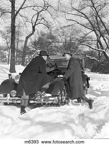 1930S Two Men Looking Under Hood Of Car Winter Snowy Street Broken Repair Cold Discussion Consultation Problem View Large Photo Image Stock Image - 1930S Two Men Looking Under Hood Of Car Winter Snowy Street Broken Repair Cold Discussion Consultation Problem . Fotosearch