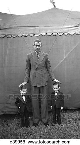 Stock Photo - 1930S Two Smallest Men In World Standing Next To Tall Man Brothers Jack And Bill Danbury Fair 1939 Extremes Large Small Short. Fotosearch