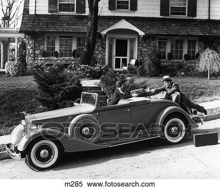 1930S Woman In Car Packard Handing Suitcase To Man In Front Of House Couple Travel Trip View Large Photo Image Stock Photography - 1930S Woman In Car Packard Handing Suitcase To Man In Front Of House Couple Travel Trip. Fotosearch