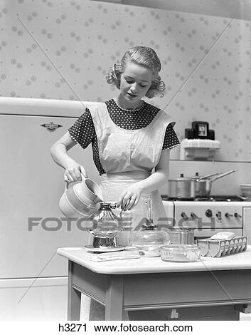 1930S Woman In Kitchen Wearing Apron Making Breakfast Pouring Water Into Coffee Pot View Large Photo Image Stock Image - 1930S Woman In Kitchen Wearing Apron Making Breakfast Pouring Water Into Coffee Pot. Fotosearch
