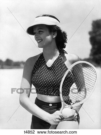 1930S Woman In Poka Dot Halter Top Dark Shorts & Sun Visor Holding A Tennis Ball & Racket View Large Photo Image Stock Image - 1930S Woman In Poka Dot Halter Top Dark Shorts & Sun Visor Holding A Tennis Ball & Racket . Fotosearch