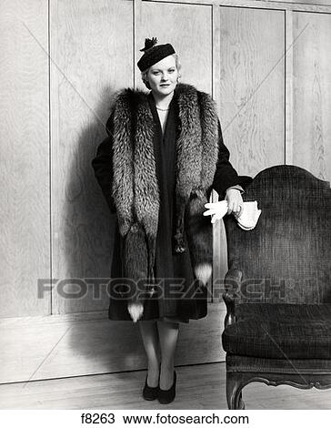 1930S Woman Wearing Long Coat And Fox Fur Stole Holding Gloves By Chair Indoor View Large Photo Image Stock Image - 1930S Woman Wearing Long Coat And Fox Fur Stole Holding Gloves By Chair Indoor . Fotosearch