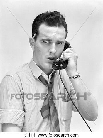 1940 1940S 1950 1950S Man With Pencil In Ear Talking On Telephone View Large Photo Image Stock Image - 1940 1940S 1950 1950S Man With Pencil In Ear Talking On Telephone . Fotosearch