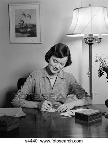 1940 1940S 1950 1950S Woman Sitting At Desk Writing Letters View Large Photo Image Stock Image - 1940 1940S 1950 1950S Woman Sitting At Desk Writing Letters . Fotosearch