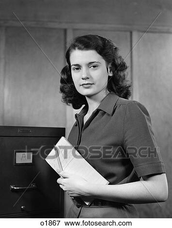 1940 1940S 1950 1950S Woman Standing Near Filing Cabinet Holding Pen And Paper View Large Photo Image Stock Photo - 1940 1940S 1950 1950S Woman Standing Near Filing Cabinet Holding Pen And Paper . Fotosearch