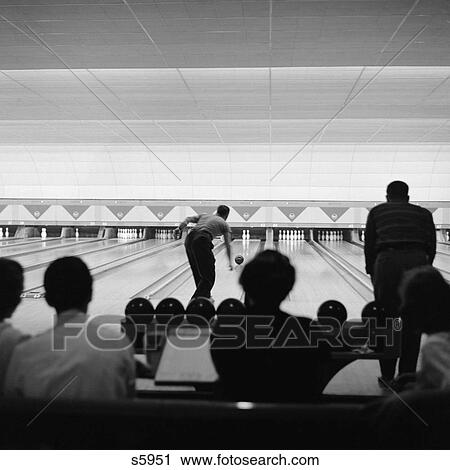 1940 1940S Bowling Alley Showing Lanes Man Bowling Silhouetted Crowd Watching View Large Photo Image Stock Image - 1940 1940S Bowling Alley Showing Lanes Man Bowling Silhouetted Crowd Watching . Fotosearch