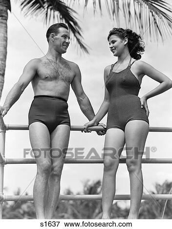 1940 1940S Couple In Bathing Suits Standing Talking View Large Photo Image Stock Photo - 1940 1940S Couple In Bathing Suits Standing Talking . Fotosearch