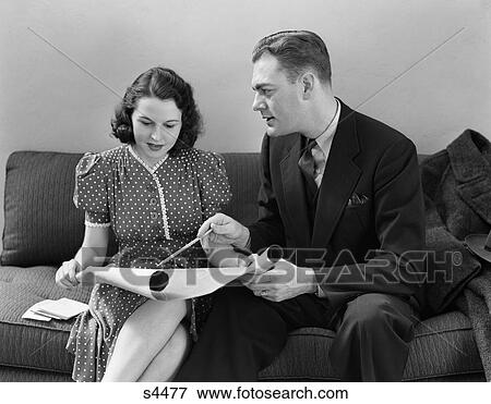 1940 1940S Couple Sitting On Couch Looking At Blueprints View Large Photo Image Stock Photo - 1940 1940S Couple Sitting On Couch Looking At Blueprints . Fotosearch