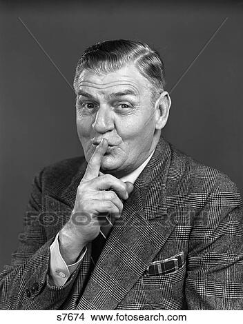 1940 1940S Elderly Man Wearing Suit Making Ssshhhh Gesture View Large Photo Image Picture - 1940 1940S Elderly Man Wearing Suit Making Ssshhhh Gesture . Fotosearch
