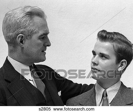 1940 1940S Man And Boy Father Son Wearing Suits Father'S Arm Around Boy View Large Photo Image Stock Photography - 1940 1940S Man And Boy Father Son Wearing Suits Father'S Arm Around Boy . Fotosearch