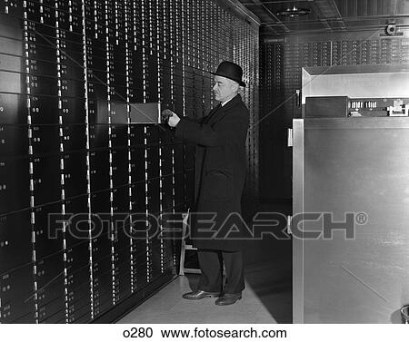 Stock Image - 1940 1940S Retro Bank Safety Deposit Man Suit Hat Finance . Fotosearch