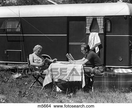 Picture - 1940 1940S Retro Couple Man Woman Trip Camping Trailer Reading Table Lunch . Fotosearch