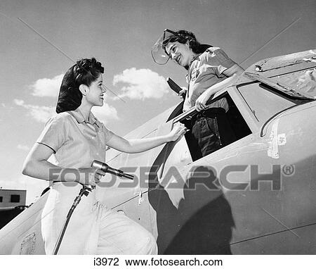 1940 1940S Two Women Wartime Workers Assemble Vega Aircraft Rosie Riveter Woman Worker Factory Airplane Ww2 Wwii World War 2 View Large Photo Image Stock Image - 1940 1940S Two Women Wartime Workers Assemble Vega Aircraft Rosie Riveter Woman Worker Factory Airplane Ww2 Wwii World War 2. Fotosearch