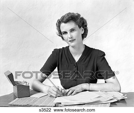 1940 1940S Woman At Desk Going Through Paperwork Paying Bills View Large Photo Image Stock Image - 1940 1940S Woman At Desk Going Through Paperwork Paying Bills . Fotosearch