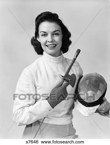 1940 1940S Woman Fencer Posing In Uniform Holding Sword And Mask View Large Photo Image Stock Photograph - 1940 1940S Woman Fencer Posing In Uniform Holding Sword And Mask . Fotosearch