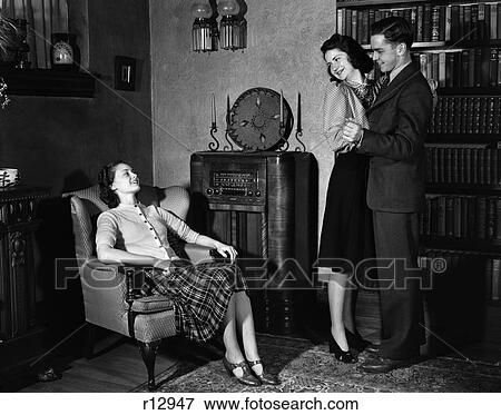 1940 1940S Young Couple Dancing To Radio Woman Sitting In Chair View Large Photo Image Stock Photo - 1940 1940S Young Couple Dancing To Radio Woman Sitting In Chair . Fotosearch