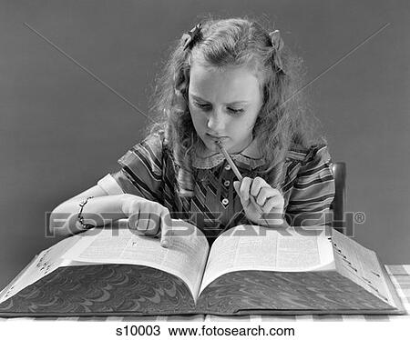 1940 1940S Young Girl Looking In Dictionary Holding Pencil To Chin View Large Photo Image Stock Image - 1940 1940S Young Girl Looking In Dictionary Holding Pencil To Chin . Fotosearch