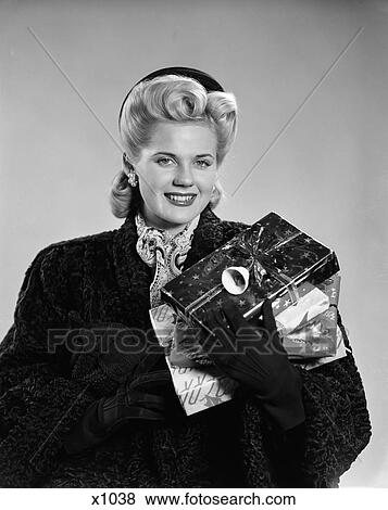 1940 1940S Young Woman In Coat And Gloves Carrying Wrapped Gifts View Large Photo Image Stock Photo - 1940 1940S Young Woman In Coat And Gloves Carrying Wrapped Gifts . Fotosearch