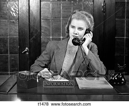 1940 1940S Young Woman Sitting At Information Desk Secretary Talking On Telephone Writing View Large Photo Image Stock Photo - 1940 1940S Young Woman Sitting At Information Desk Secretary Talking On Telephone Writing . Fotosearch