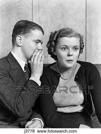 1940S 1930S Young Teen Couple Boy Whispering Into Girls Ear Girl With Amazed Surprised Expression View Large Photo Image Stock Photo - 1940S 1930S Young Teen Couple Boy Whispering Into Girls Ear Girl With Amazed Surprised Expression . Fotosearch