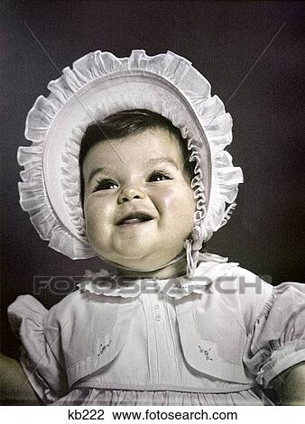 1940S 1950S Baby Brunette Portrait Wear White Ruffled Dress Big Bonnet Hat View Large Photo Image Stock Image - 1940S 1950S Baby Brunette Portrait Wear White Ruffled Dress Big Bonnet Hat. Fotosearch