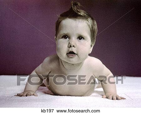 Stock Photo - 1940S 1950S Baby Raising Head Up Pushing With Arms Like Push Up Exercise. Fotosearch