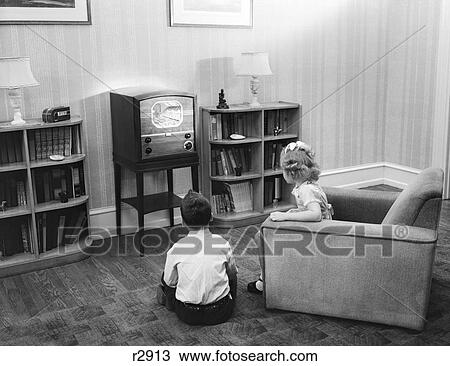 1940S 1950S Boy And Girl With Backs To Viewer In Living Room Watching A Small Screen Television View Large Photo Image Stock Image - 1940S 1950S Boy And Girl With Backs To Viewer In Living Room Watching A Small Screen Television. Fotosearch