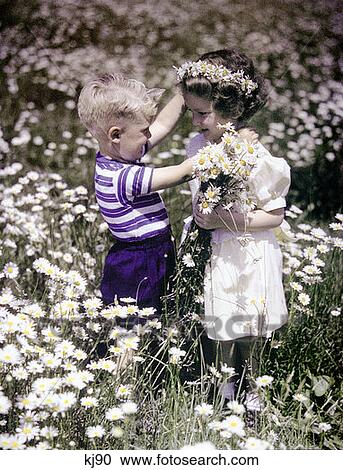 1940S 1950S Boy Girl Outdoor Field Of Daisies Picking Flowers View Large Photo Image Stock Image - 1940S 1950S Boy Girl Outdoor Field Of Daisies Picking Flowers. Fotosearch