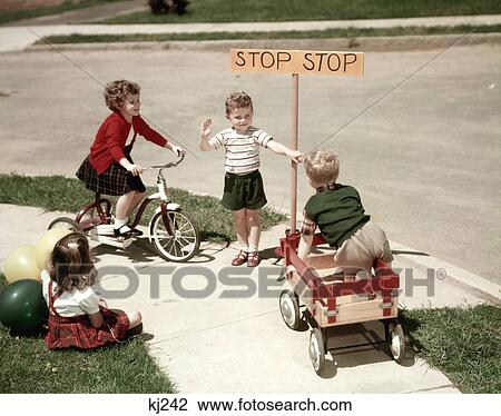 1940S 1950S Boys And Girls Outdoor With Tricycle And Wagon Playing Traffic With Police Stop Sign Americana Nostalgia View Large Photo Image Stock Image - 1940S 1950S Boys And Girls Outdoor With Tricycle And Wagon Playing Traffic With Police Stop Sign Americana Nostalgia . Fotosearch