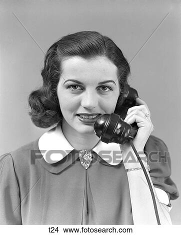 Picture - 1940S 1950S Brunette Woman Smiling Hold Telephone To Ear Dress With White Collar . Fotosearch
