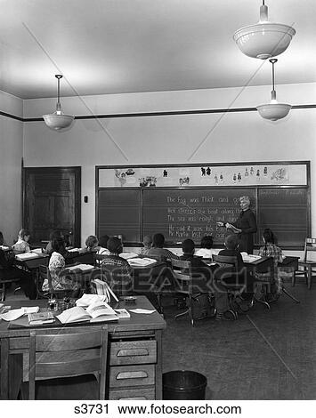 1940S 1950S Elementary Classroom Grade School Students At Desks Facing Teacher View Large Photo Image Stock Image - 1940S 1950S Elementary Classroom Grade School Students At Desks Facing Teacher. Fotosearch