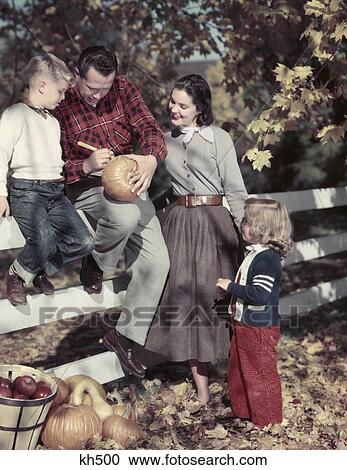 1940S 1950S Family Father Mother Son And Daughter Outdoor Carving A Pumpkin Americana Nostalgia View Large Photo Image Stock Image - 1940S 1950S Family Father Mother Son And Daughter Outdoor Carving A Pumpkin Americana Nostalgia . Fotosearch
