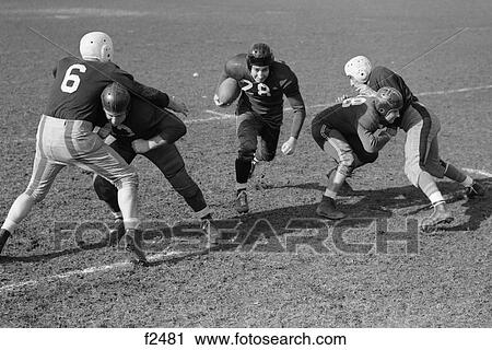 1940S 1950S Football Player Running With Ball As Blockers Defend Him View Large Photo Image Stock Image - 1940S 1950S Football Player Running With Ball As Blockers Defend Him . Fotosearch