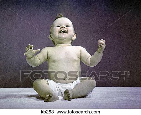 Stock Image - 1940S 1950S Full Body Sitting Baby Laughing Hands Arms Raised. Fotosearch