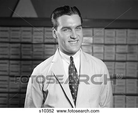 1940S 1950S Salesman In White Coat And Tie Smiling Portrait Pharmacist Inventory In Background View Large Photo Image Stock Image - 1940S 1950S Salesman In White Coat And Tie Smiling Portrait Pharmacist Inventory In Background . Fotosearch